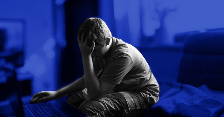 Black and white edit of a child sits hiding his face in one hand
