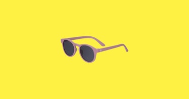 a pair of kids sunglasses, set against a bright-yellow background