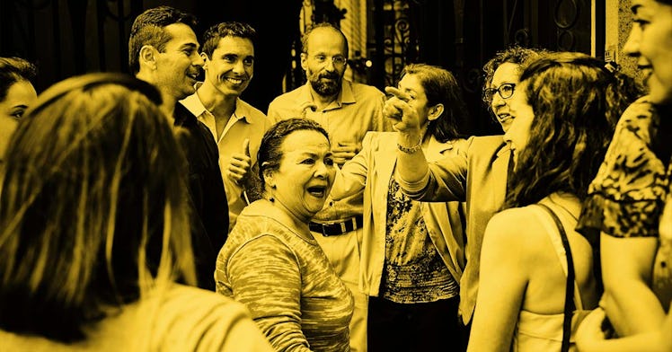 Happy people at a family gathering, dancing and talking to each other, captured through a yellow fil...