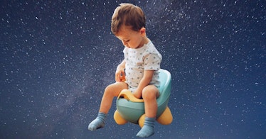 A child sitting on a potty training toilet against a dark blue background.