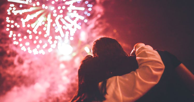 Two people watching fireworks together.