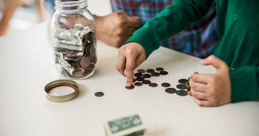 close up shot of a parent calculating how much to contribute to a 529 account