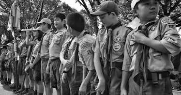 A group of Boy Scouts stands in black and white