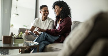 Couple doing communication exercises on a couch next to one another.