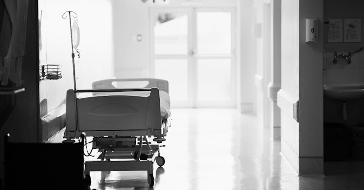 an empty hospital bed is seeni n black and white