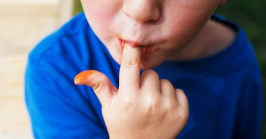 A child licking his finger