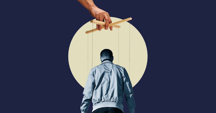 A hand holding a man controlling him on strings like a puppet