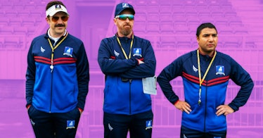 Three soccer coaches from "Ted Lasso"  standing on the field, in their blue tracker suits, watching ...