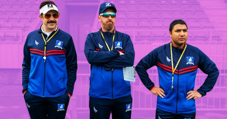 Three soccer coaches from "Ted Lasso" standing on the field, in their blue tracker suits, watching ...