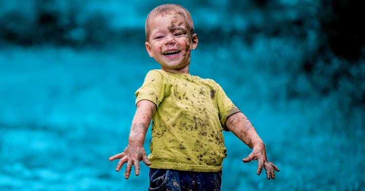 dirty kid showing off mud