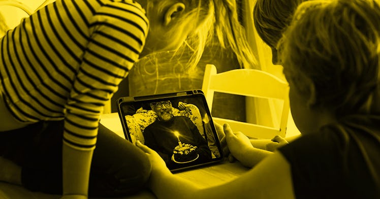 Two kids on a video call with their grandfather