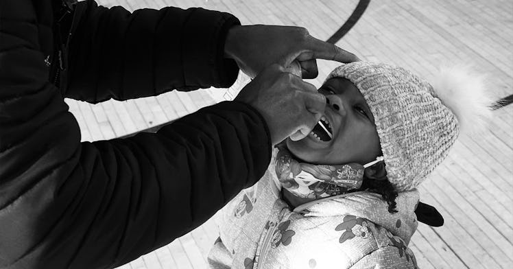 black and white edit of a child receiving a COVID test nasal swab.