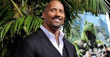 Dwayne Johnson stands and smiles