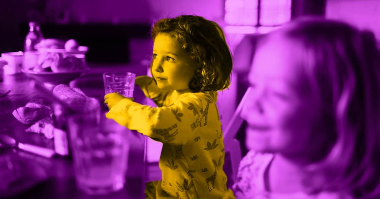 2 kids practice good table manners while eating