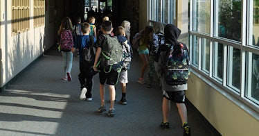 Kids walk through a school hallway