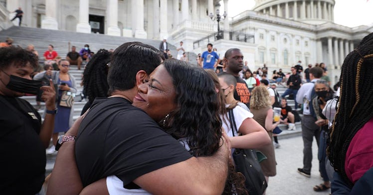 Representative Cori Bush hugs someone at the White House steps