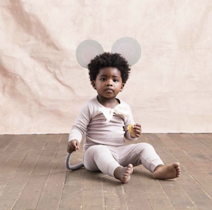 A little boy wearing a white Mouse costume