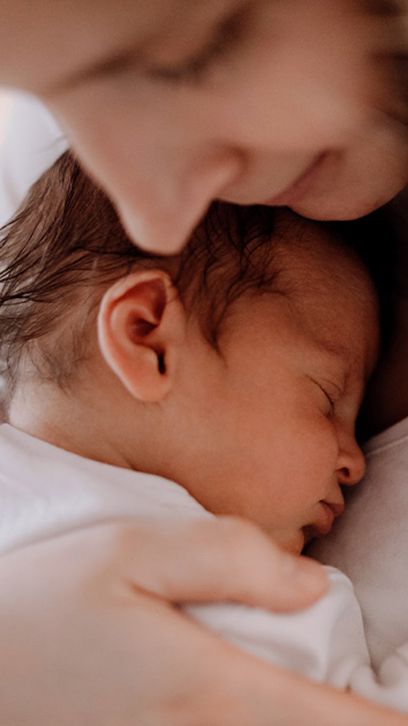 A mom embraces her baby