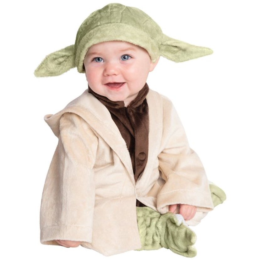 A little boy wearing a Yoda costume