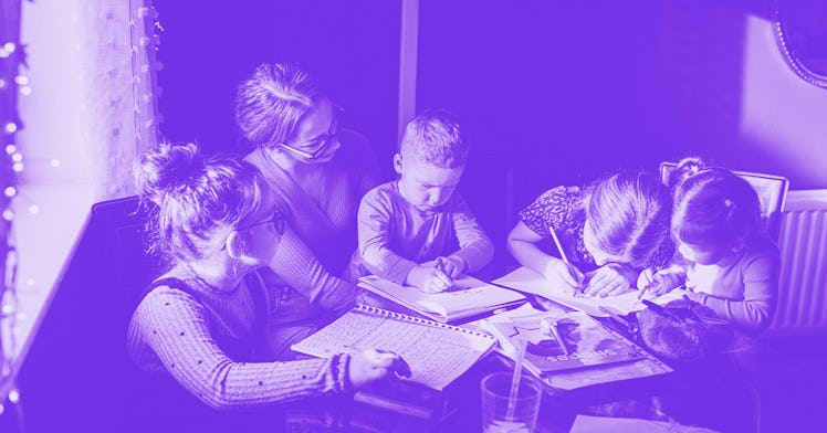 A group of kids work at a table, in a purple filter