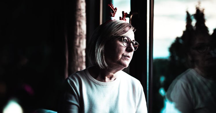A woman wears antler ears on in an apparent Christmas celebration