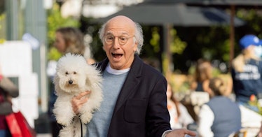 Larry David holding a dog