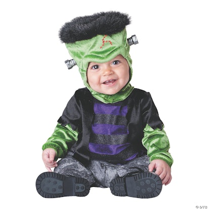 A boy posing while wearing a Frankenstein’s Monster costume