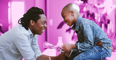 a father and child collaborating in play