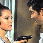 Diana Rigg pointing a gun on George Lazenby in 1969 James Bond