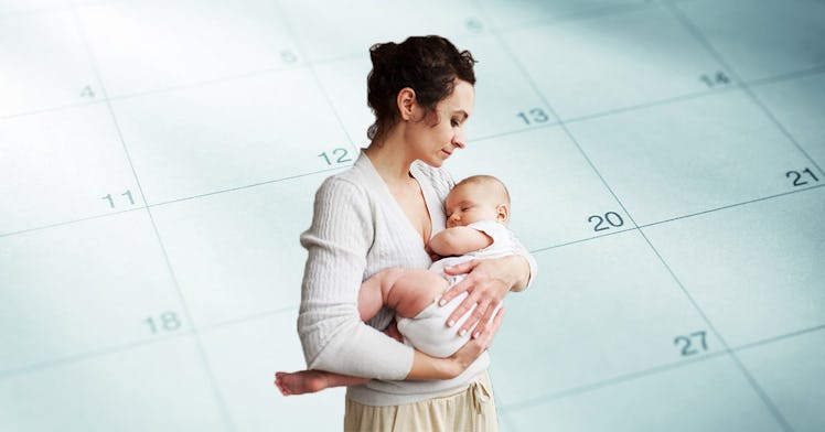 A mom holds a baby in front of a calendar