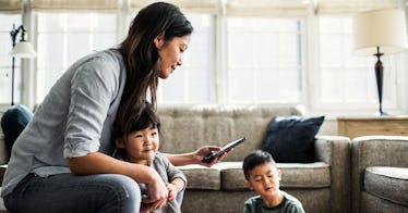 A mom trying to spend time with her kids while answering after-hours work emails on her phone