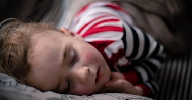 A child with a pained face lying down