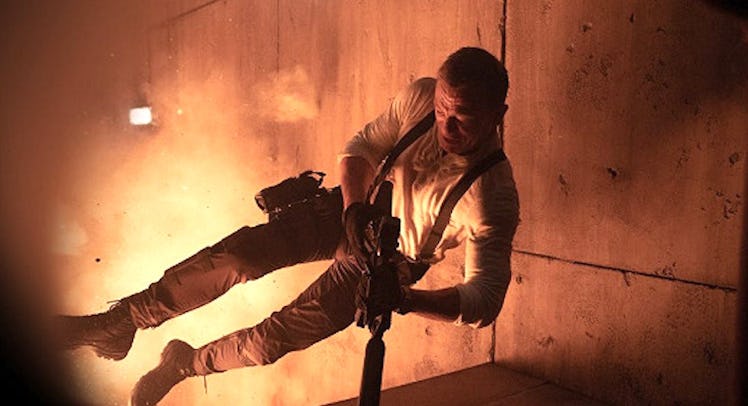 A scene from the James Bond movie with Daniel Craig falling with a gun in his hand