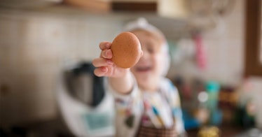 a baby holding an egg