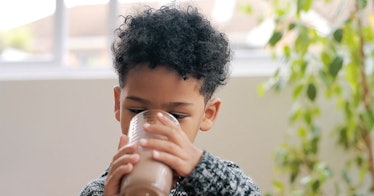 Young child drinking fiber supplements for kids.