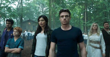 Richard Madden as Ikaris from Eternals standing next to his co-stars in a forest