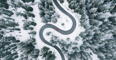A car road in the middle of a mountain full of snow