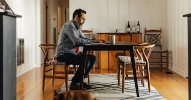 a man works at his desk in his house