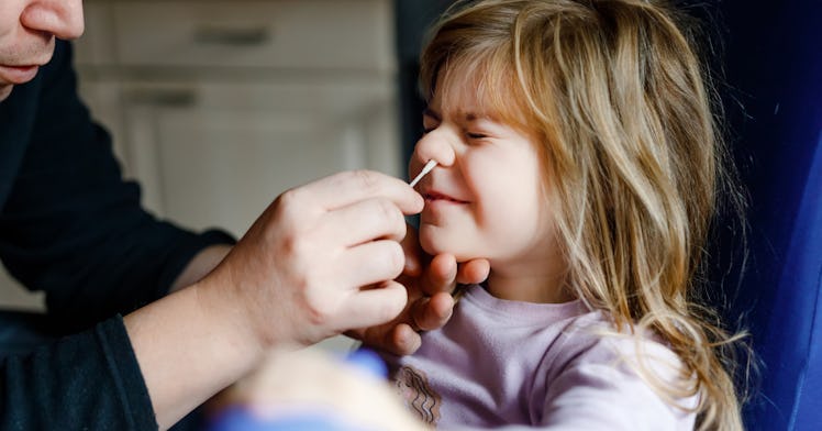 dad giving daughter at home covid test
