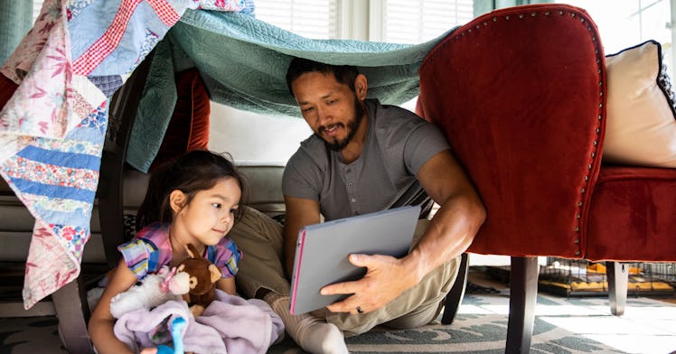 dad raising family playing with girl in a fort