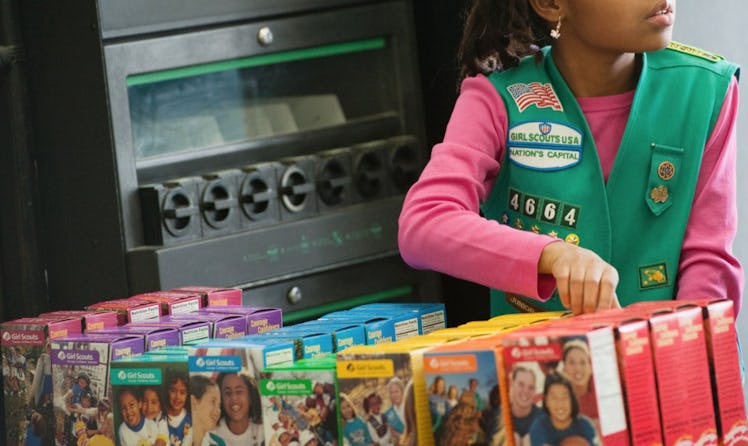 girl selling girl scout cookies