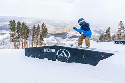 A boy snowboarding at the Keystone, CO ski resort