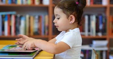 girl sitting at library desk