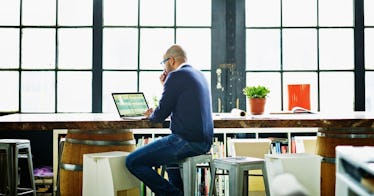 man-seated-at-computer-trying-to-make-decision