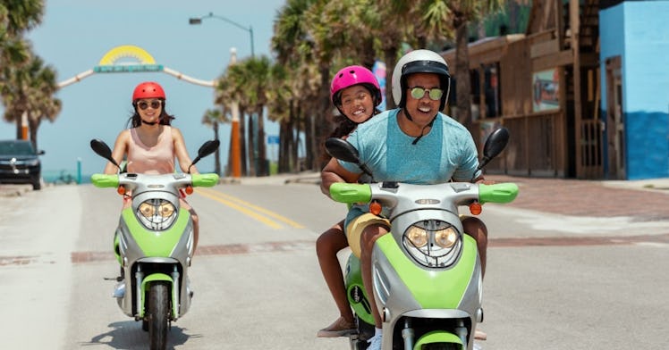 tourists riding mopeds on a sunny Florida day