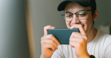 a man plays a game on his phone