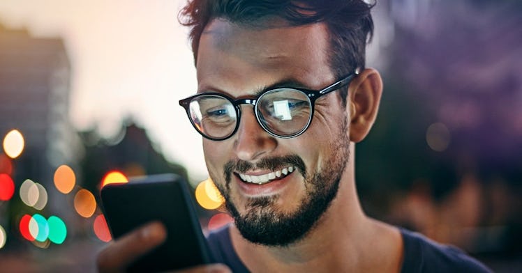 Man-smiling-staring-at-phone
