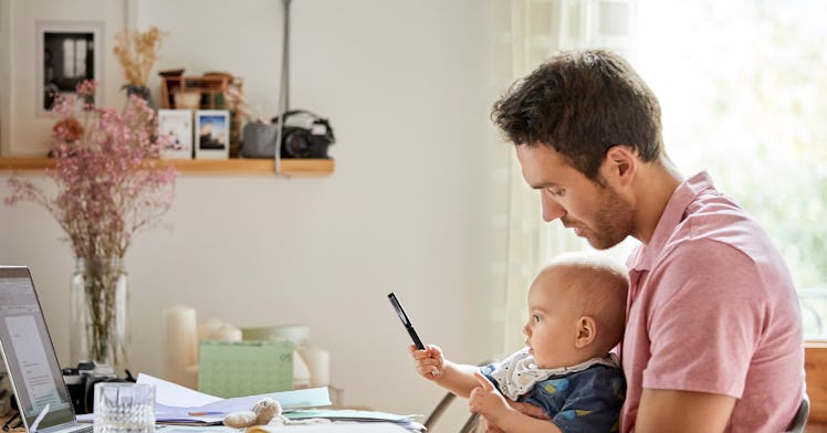 dad looking at finances with baby