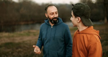 Father talking to son in open field