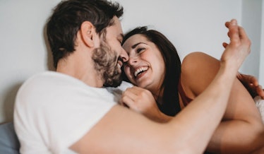 happy-couple-in-bed-laughing